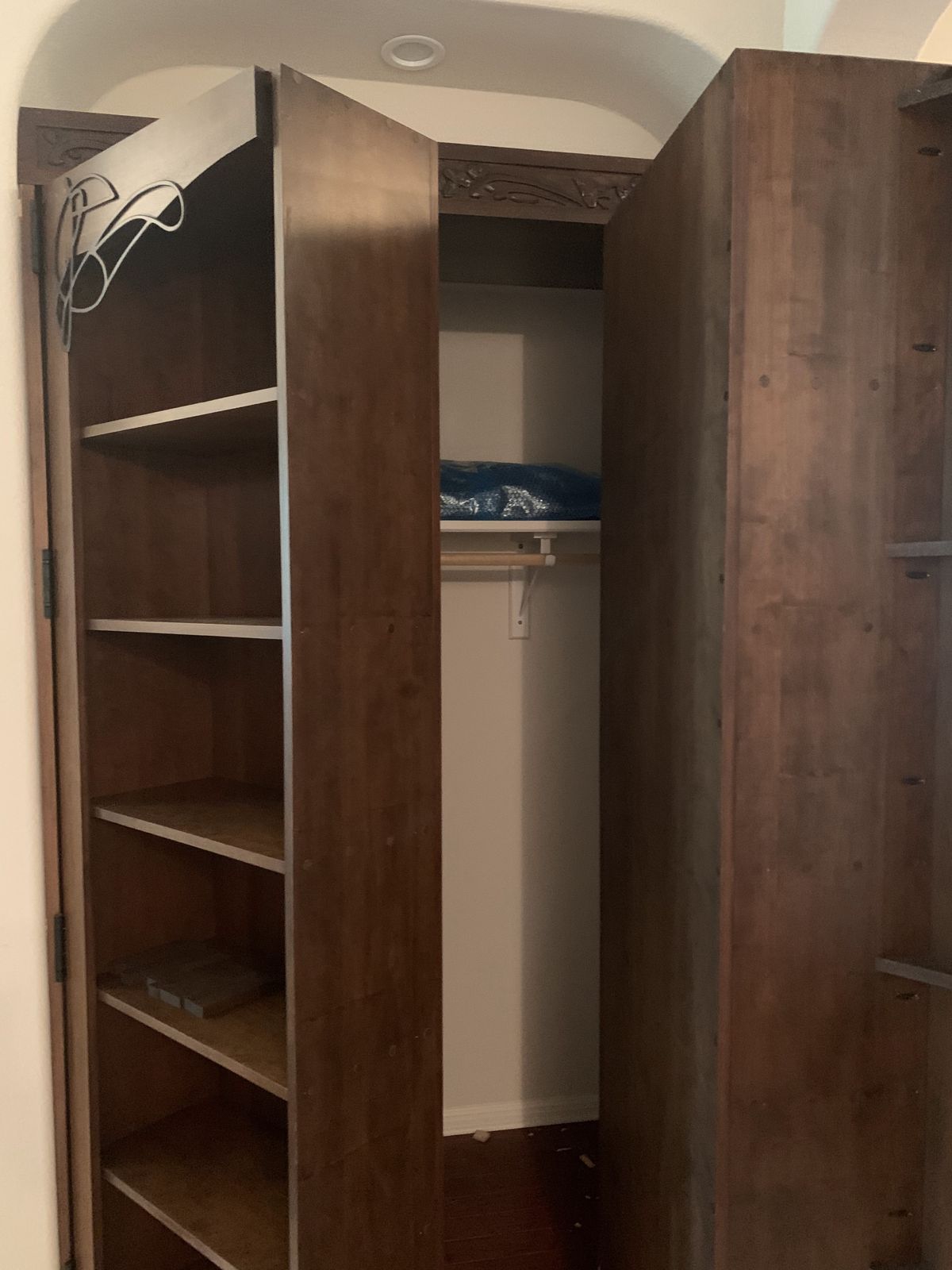 The same bookcase swung open to reveal a closet behind it