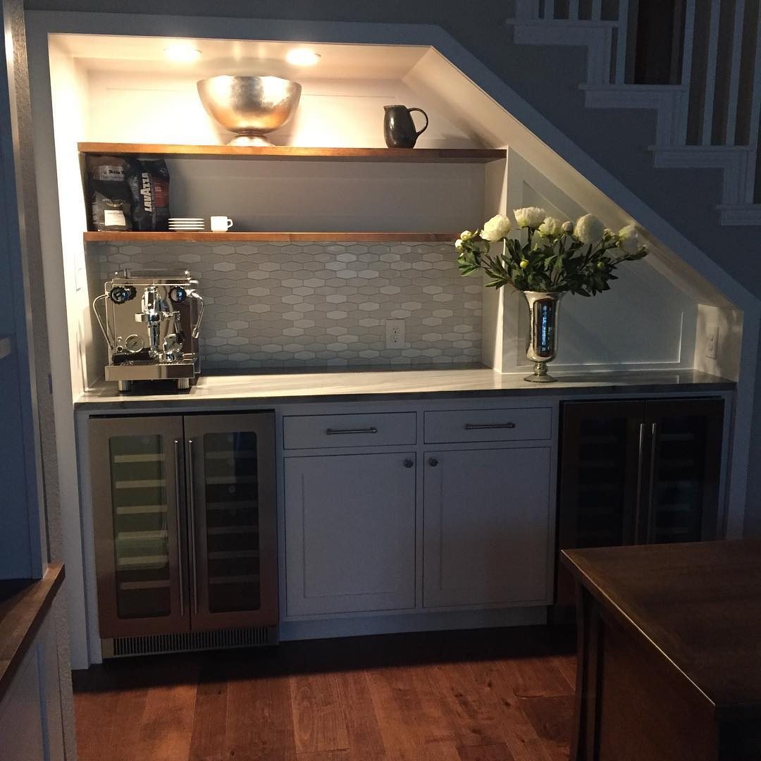 Under-stair coffee bar with grey cabinets, lit floating shelves and a wine fridge