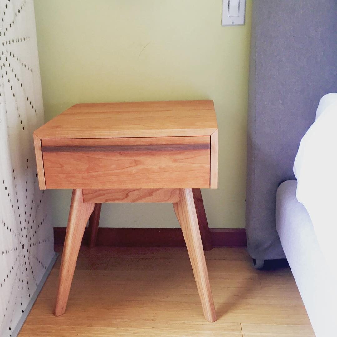 Cherry nightstand with a single drawer and tapered legs