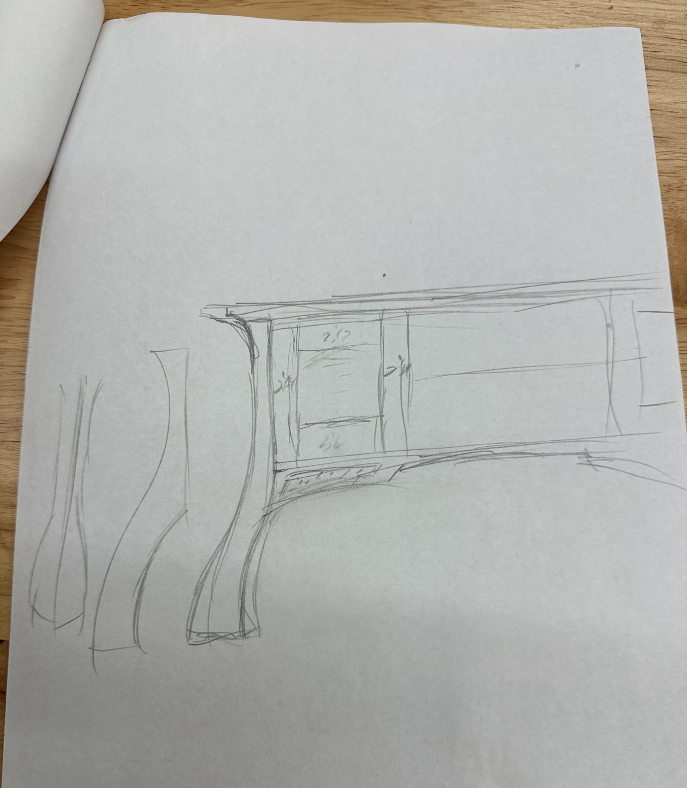 Pencil sketch of a cabinet with curved legs, drawn at the bench